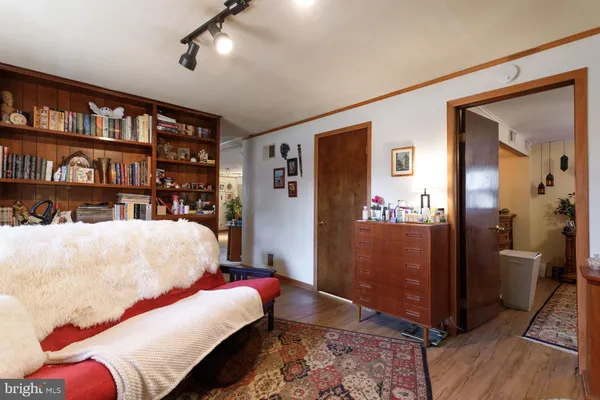 a bedroom with furniture and wooden floor