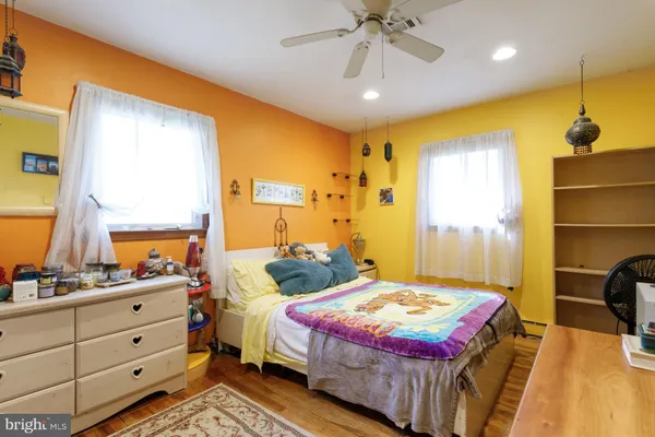 a bathroom with a granite countertop sink mirror vanity and a toilet