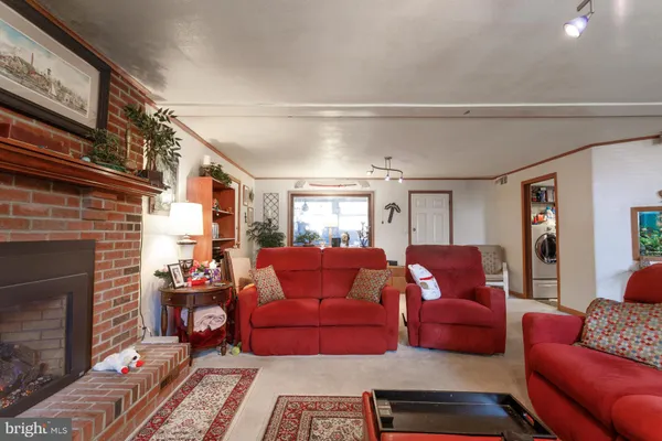 a living room with furniture a fireplace and a window