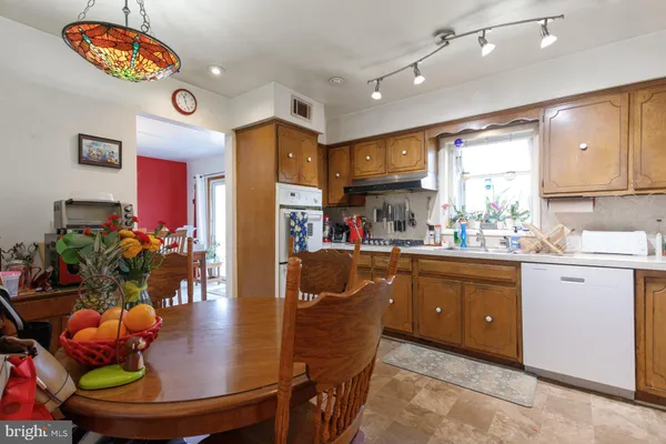 a kitchen with stainless steel appliances granite countertop a sink a refrigerator and a stove