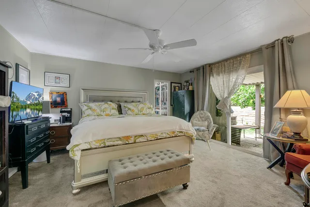 a bedroom with a bed chair and window