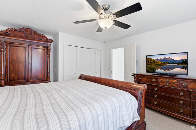 1878 East Ridge Point Drive Bountiful, UT 84010 - Photo 43 of 92 Bedroom with a closet, ceiling fan, and light carpet