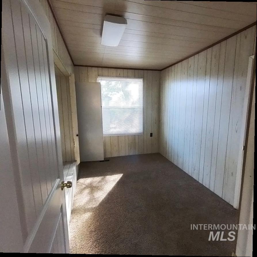 418 13th Street Clarkston, WA 99403 - Photo 13 of 26 Unfurnished room with carpet floors, wood walls, and wood ceiling