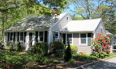 79 Earle Road West Harwich, MA 02671 - Photo 1 of 30 a view of a house with brick walls and flower plants