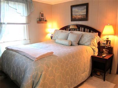 79 Earle Road West Harwich, MA 02671 - Photo 12 of 30 a bedroom with a bed and a lamp on dresser