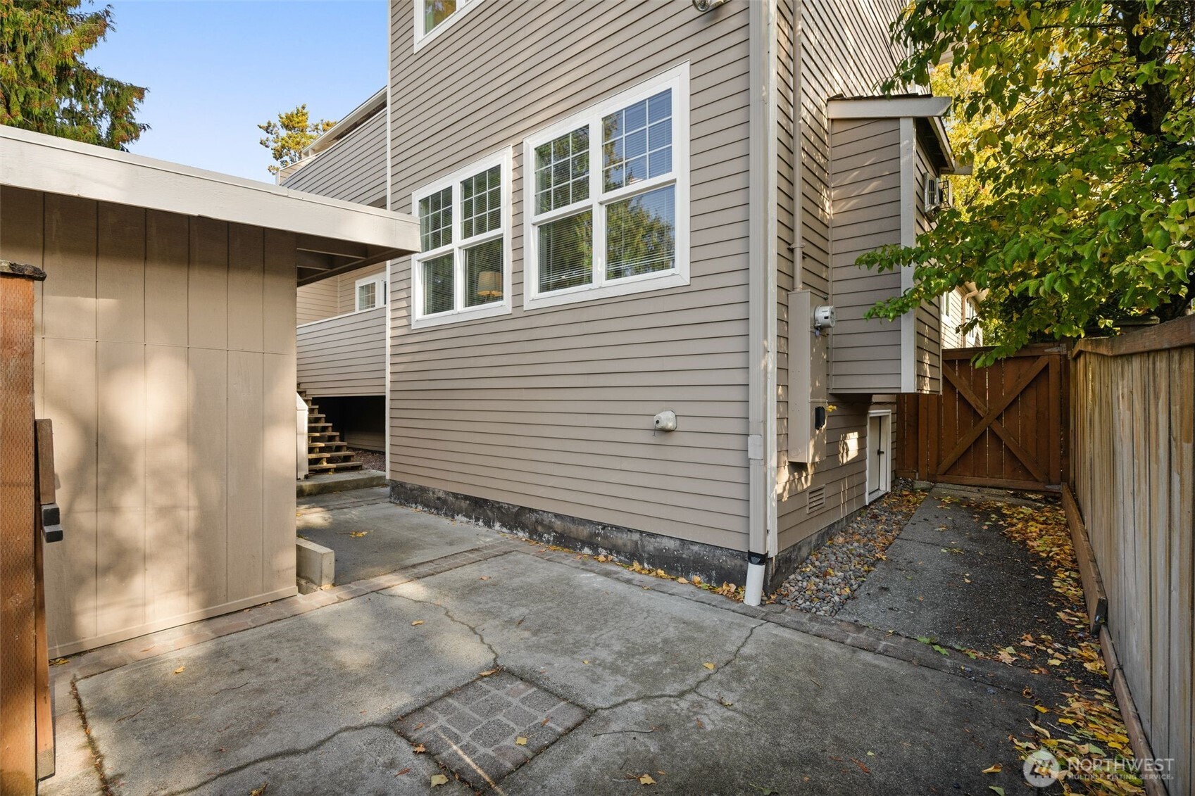 6507 41st Avenue Southwest Seattle, WA 98136 - Photo 29 of 37 a view of a house with a door and wooden fence