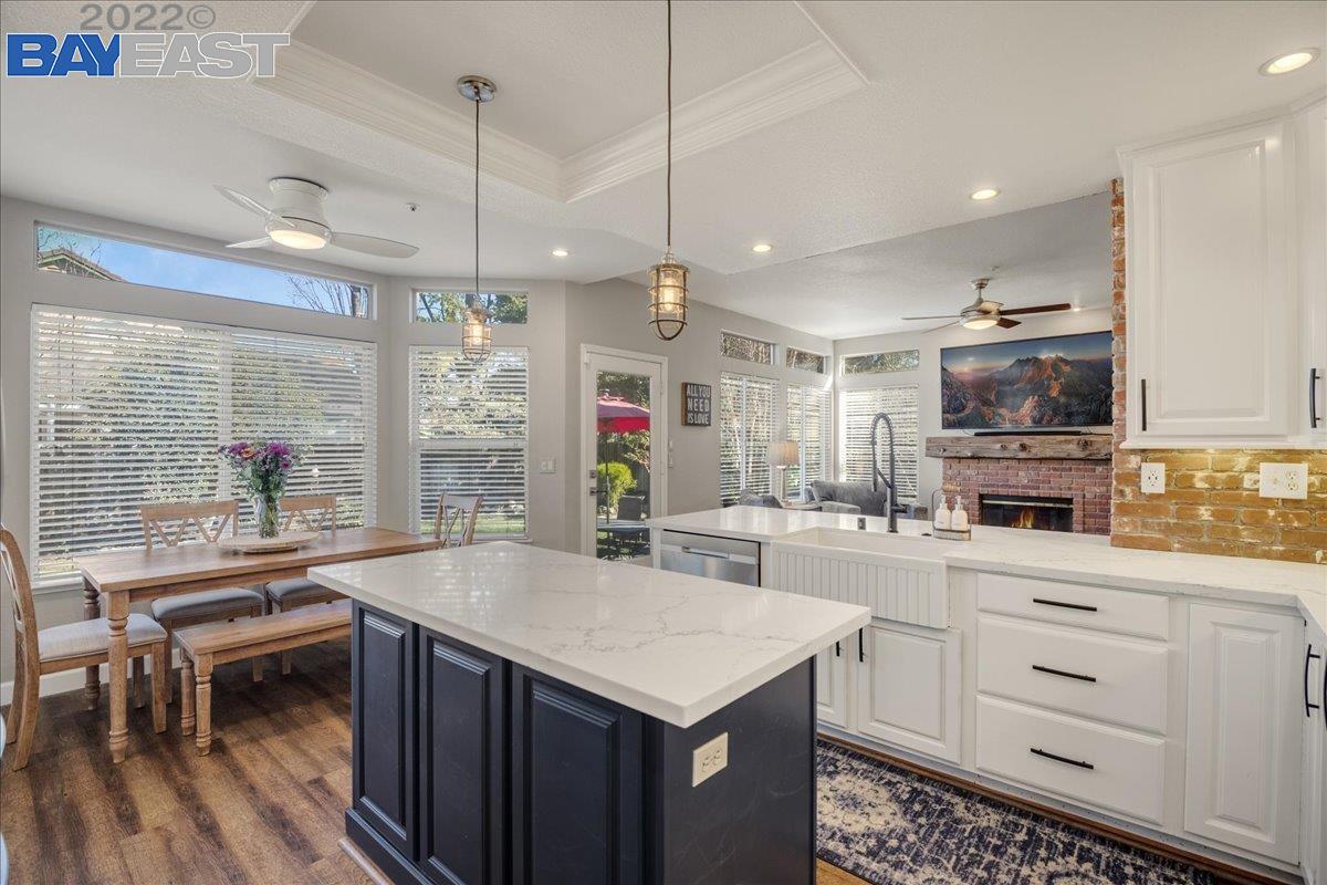 a kitchen with stainless steel appliances kitchen island granite countertop a sink stove and cabinets