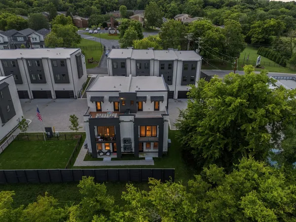 an aerial view of a house with garden space and street view