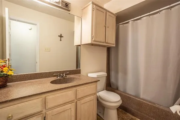 a kitchen with a stove and white cabinets