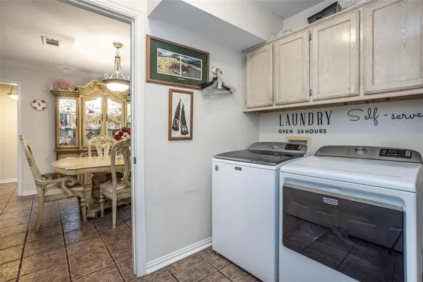 a bedroom with a bed and a flat tv screen on dresser