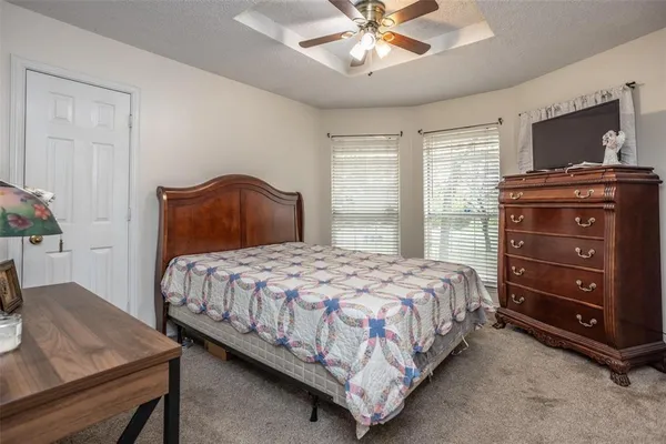 a bathroom with a granite countertop tub sink and mirror