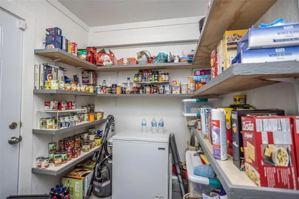 a view of a park with trees and wooden fence