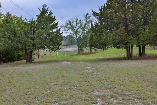 an aerial view of a house with a yard and lake view