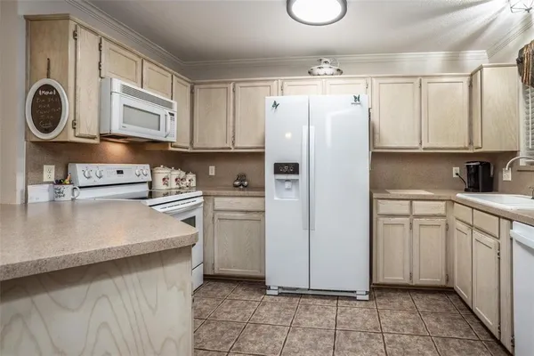 a kitchen with stainless steel appliances a refrigerator sink and cabinets