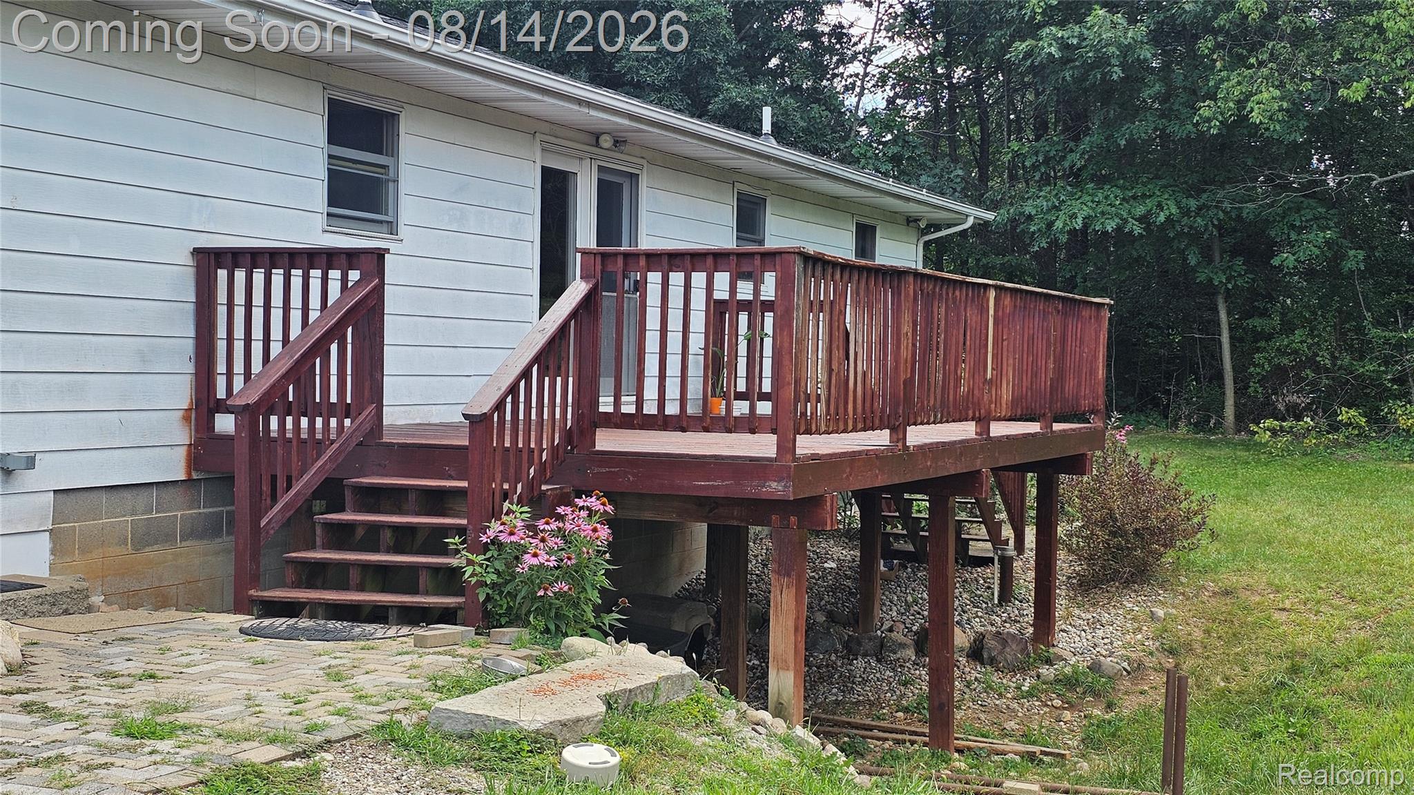 7966 Pettysville Road Pinckney, MI 48169 - Photo 35 of 43 Expansive wooden deck with railing, siding exterior, and a glass sliding door