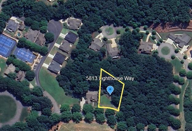 an aerial view of a house with garden space and street view