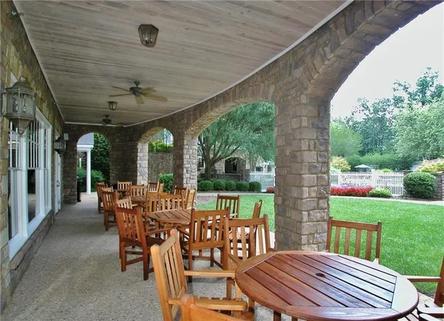 a view of a patio with a table chairs and backyard