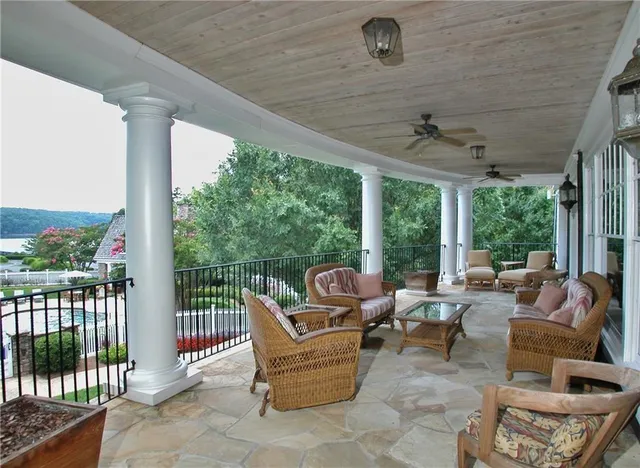 a living room with patio furniture and a floor to ceiling window