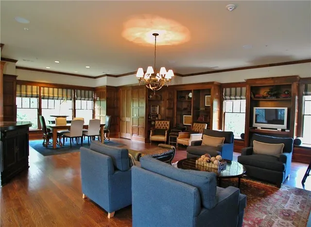 a living room with furniture and a chandelier