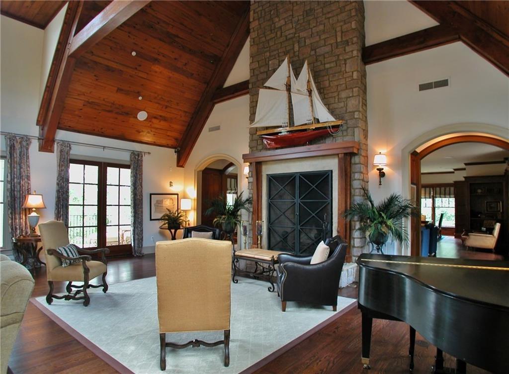 5813 Lighthouse Way Gainesville, GA 30506 - Photo 27 of 49 a living room with furniture a fireplace and large windows