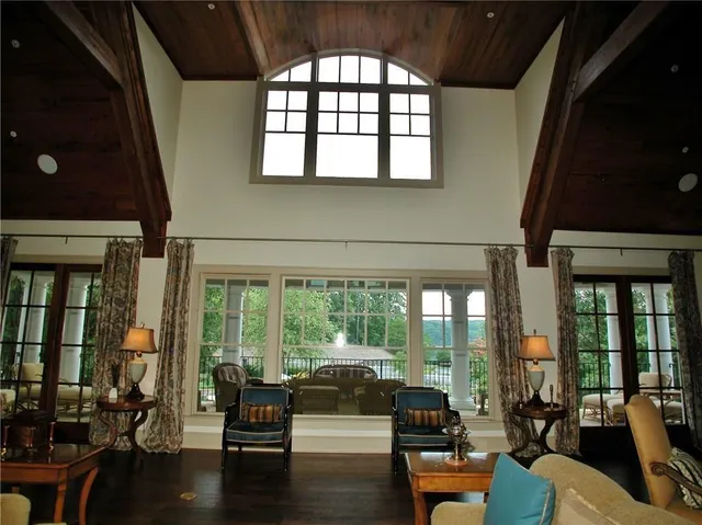 a living room with furniture and floor to ceiling windows