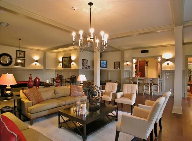 a living room with furniture a chandelier and a chandelier