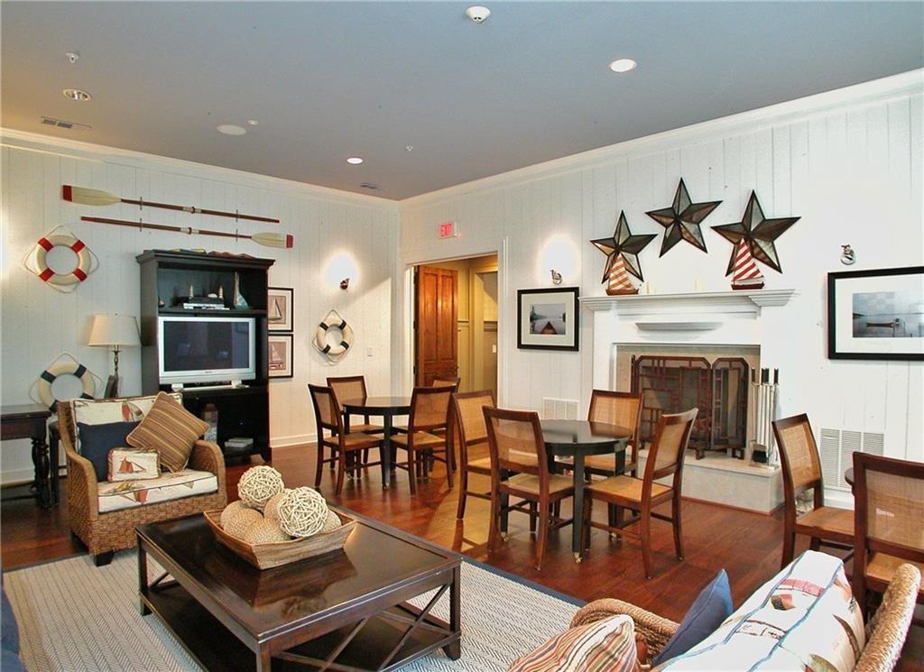 5813 Lighthouse Way Gainesville, GA 30506 - Photo 34 of 49 a living room with furniture a fireplace and a flat screen tv