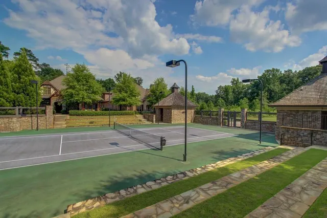 a front view of a house with swimming pool and sitting area