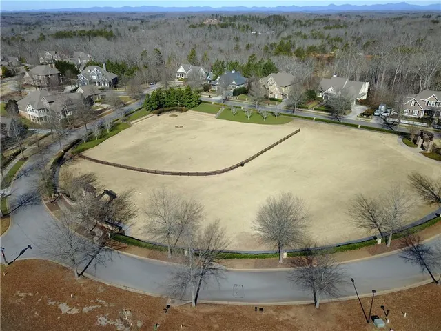 an aerial view of a residential houses with swimming pool and outdoor space