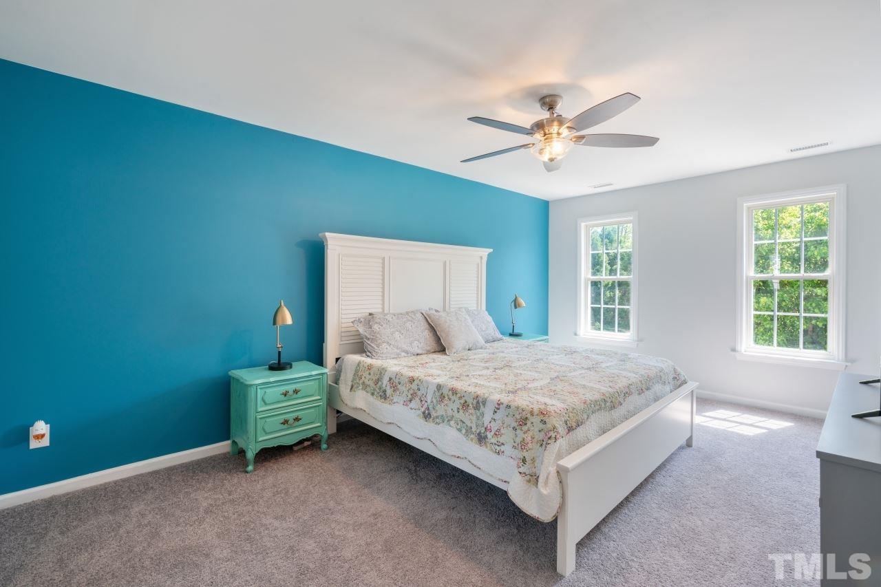 2133 Haig Point Way Raleigh, NC 27604 - Photo 14 of 28 a bed room with a bed and a ceiling fan
