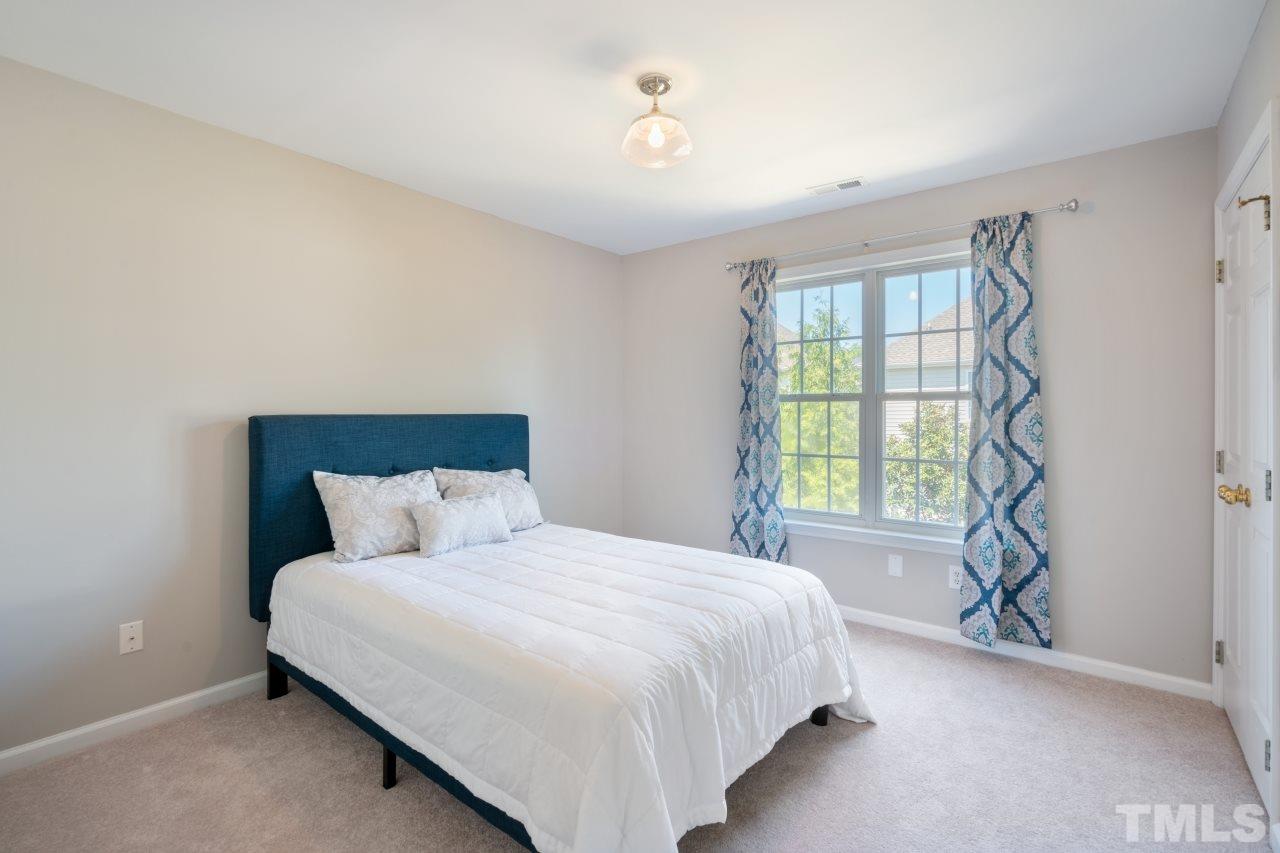 2133 Haig Point Way Raleigh, NC 27604 - Photo 18 of 28 a bedroom with a bed and a window