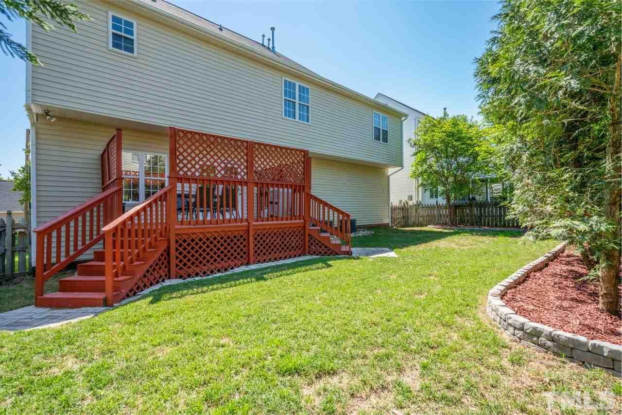 2133 Haig Point Way Raleigh, NC 27604 - Photo 26 of 28 a view of a house with a small yard and wooden fence