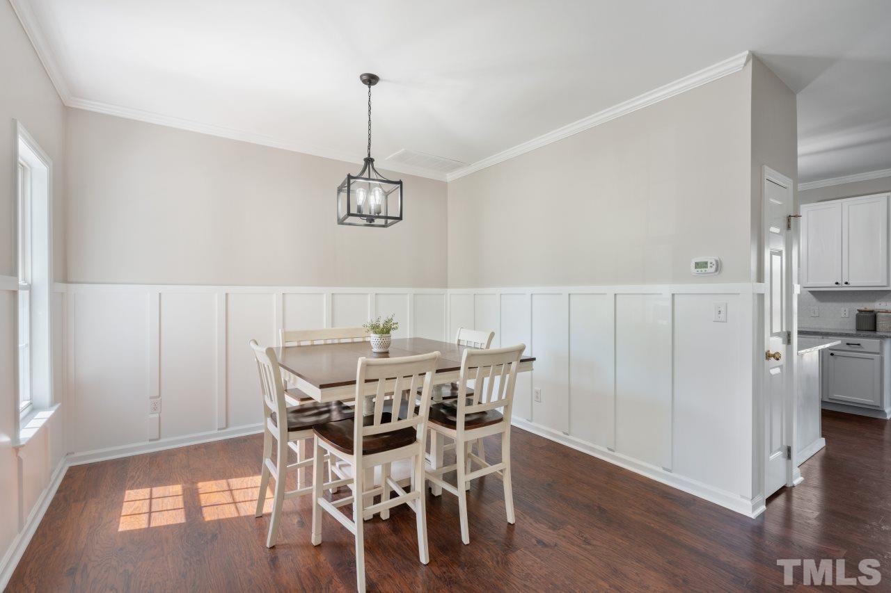 2133 Haig Point Way Raleigh, NC 27604 - Photo 4 of 28 a view of a dining room with furniture wooden floor and chandelier