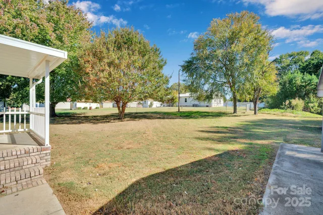 a livingroom with furniture and floor to ceiling window