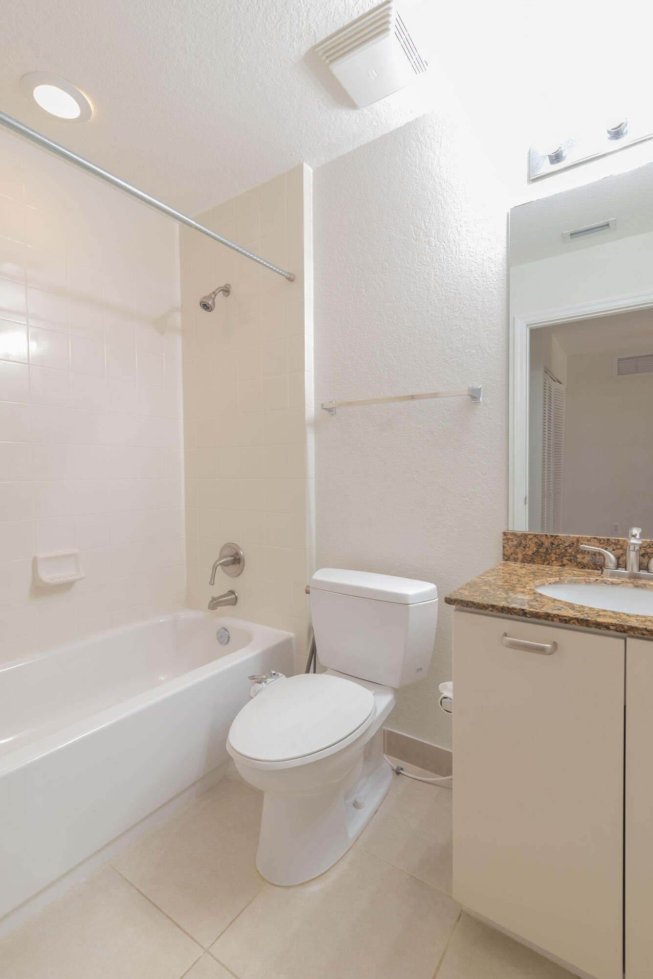 53 Southeast Sedona Circle, Unit 106 Stuart, FL 34994 - Photo 11 of 19 a white toilet sitting next to a bath tub