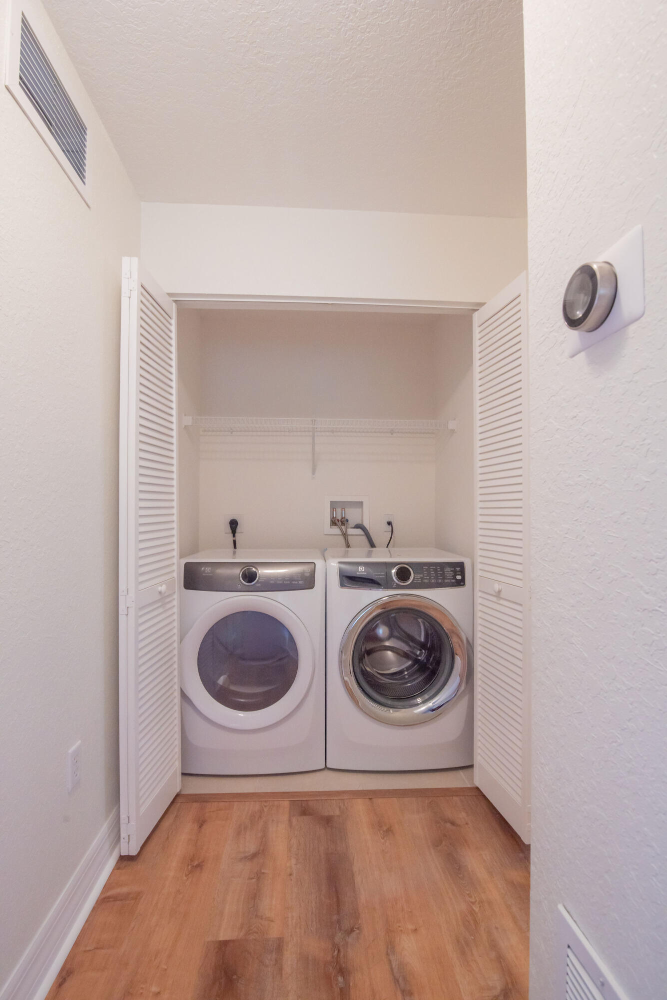 53 Southeast Sedona Circle, Unit 106 Stuart, FL 34994 - Photo 12 of 19 a utility room with dryer and washer