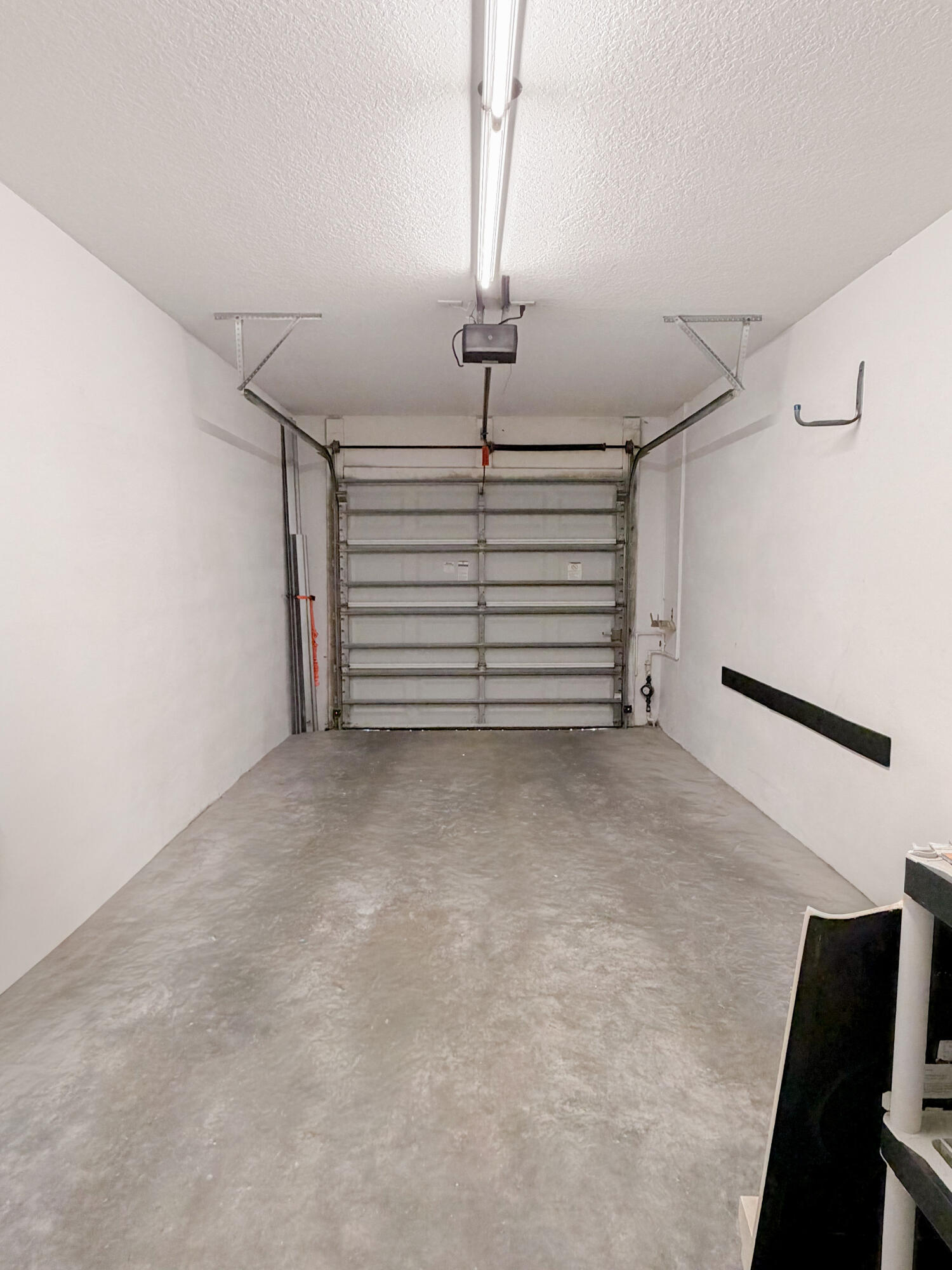 53 Southeast Sedona Circle, Unit 106 Stuart, FL 34994 - Photo 15 of 19 a view of a room with stairs and a ceiling fan