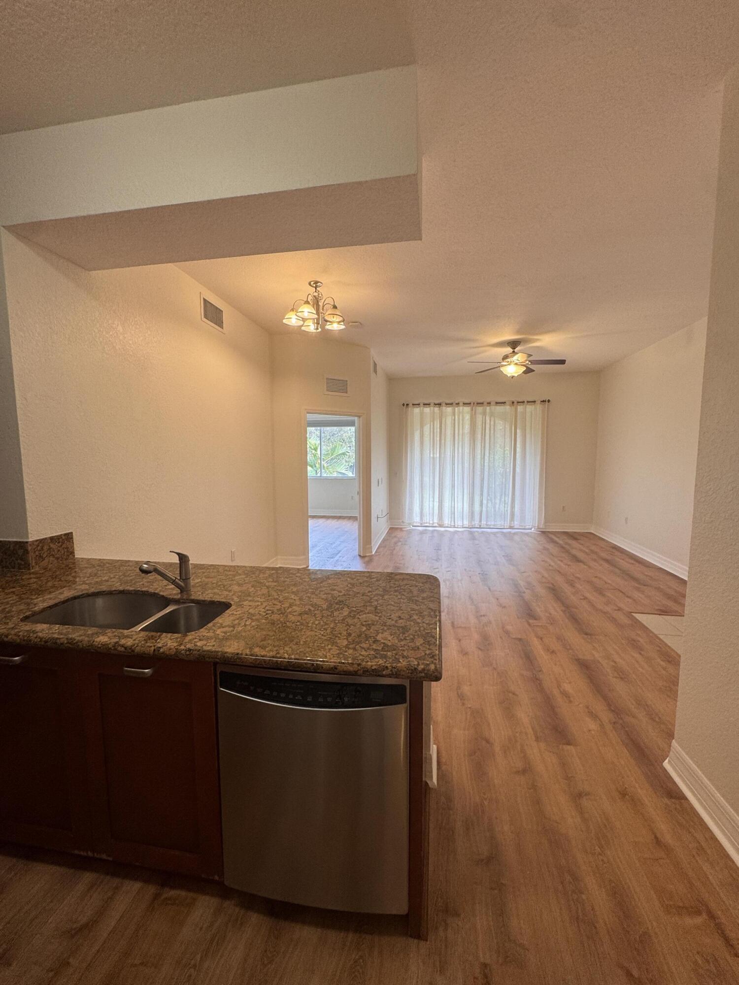 53 Southeast Sedona Circle, Unit 106 Stuart, FL 34994 - Photo 2 of 19 a kitchen with a sink and a mirror