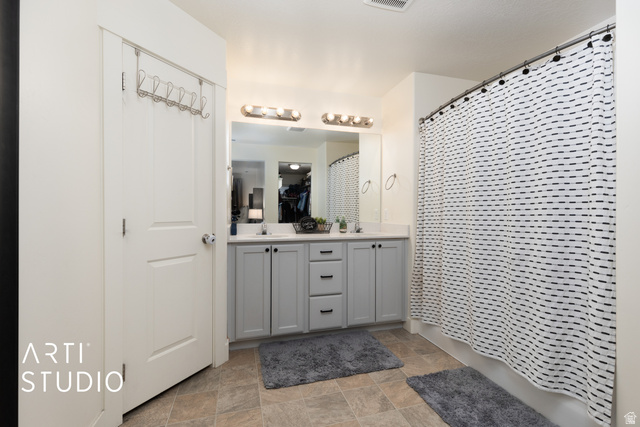 1713 South Windemere Road Santaquin, UT 84655 - Photo 16 of 40 Bathroom featuring a dual vanity with light gray cabinetry, a white countertop, and a large mirror
