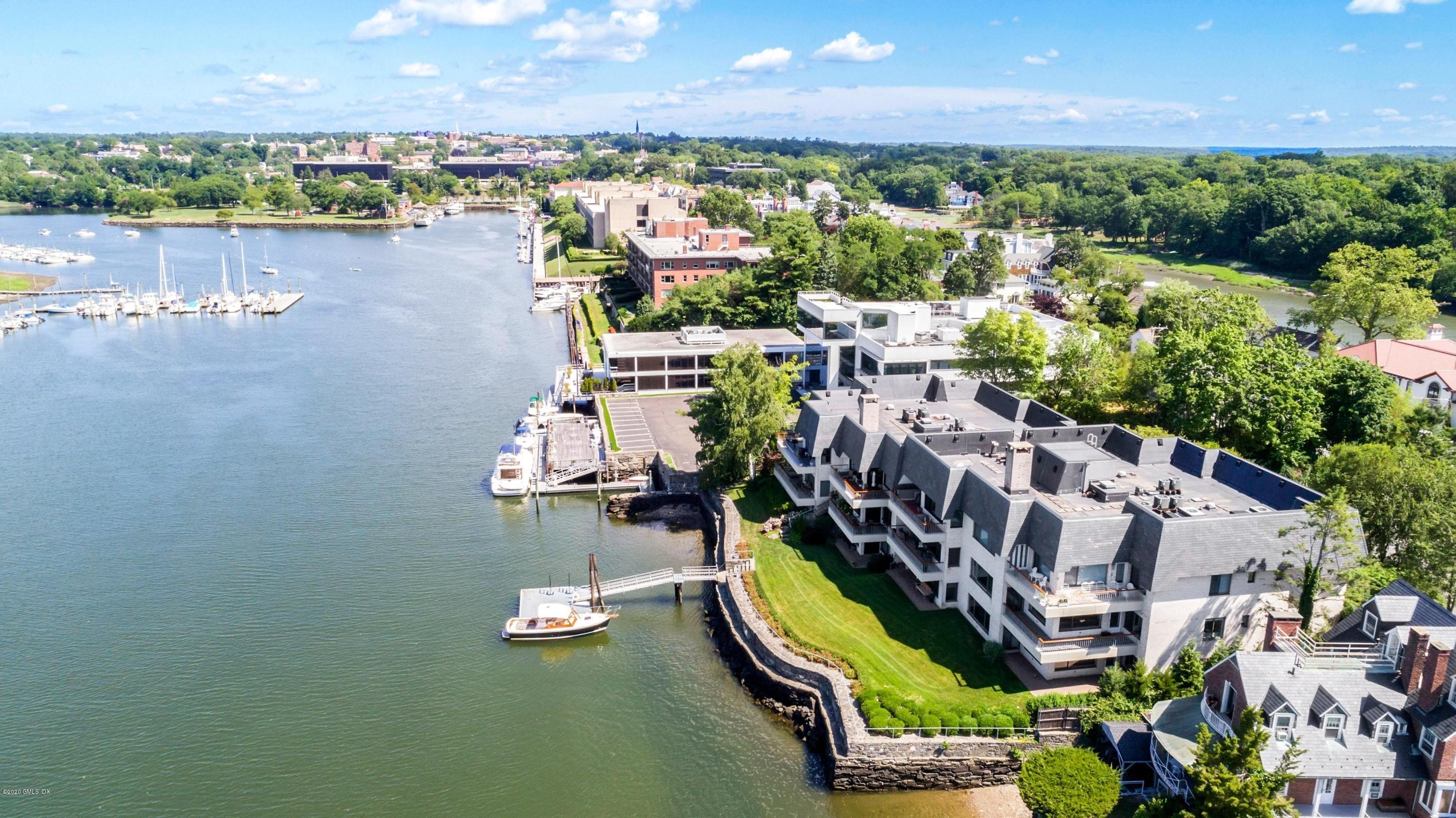 680 Steamboat Road, Unit 5 Greenwich, CT 06830 - Photo 1 of 21 a view of a city with lawn chairs under an umbrella