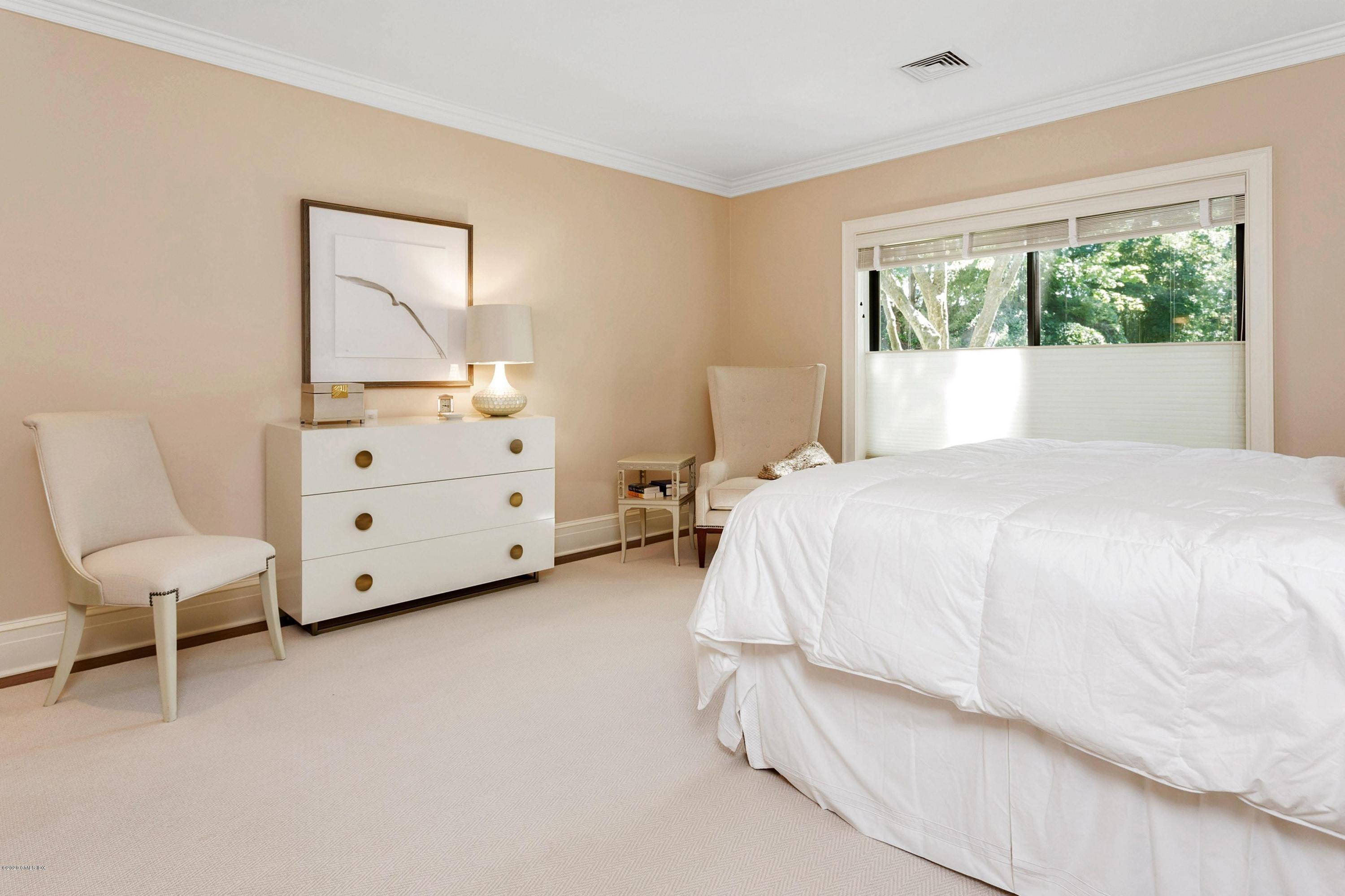 680 Steamboat Road, Unit 5 Greenwich, CT 06830 - Photo 11 of 21 a large white bed sitting in a bedroom next to a window