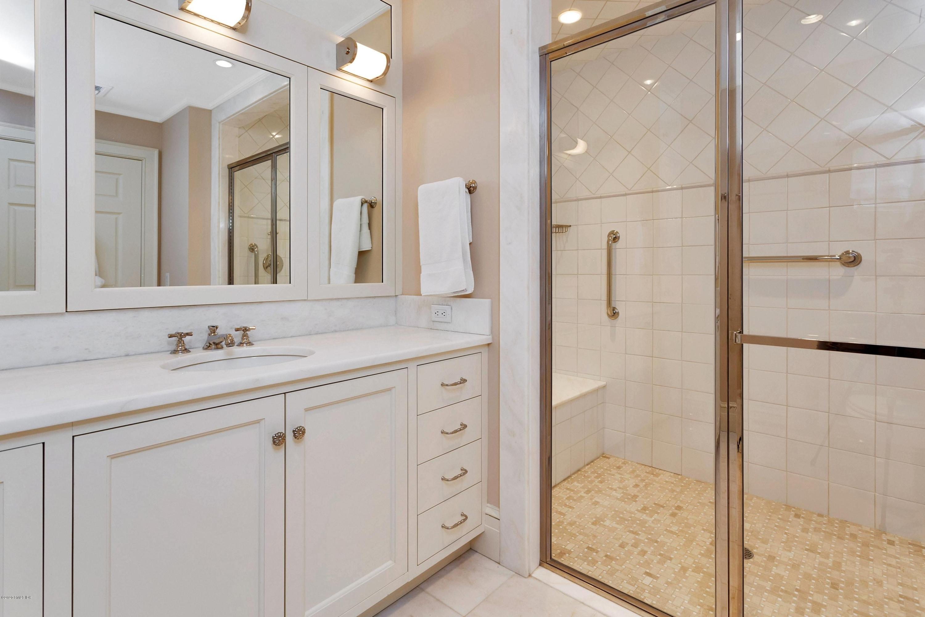 680 Steamboat Road, Unit 5 Greenwich, CT 06830 - Photo 12 of 21 a bathroom with a shower sink and mirror