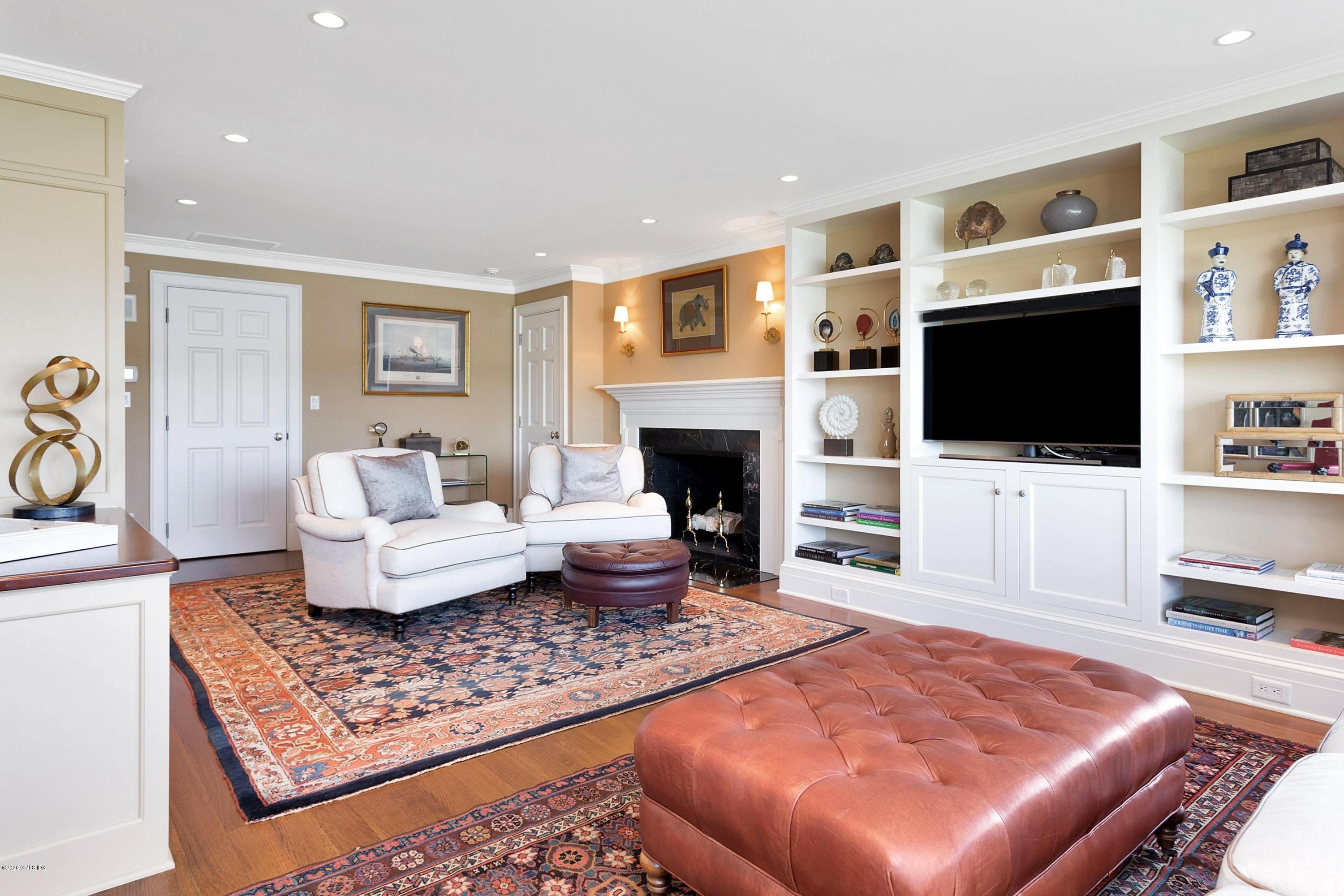 680 Steamboat Road, Unit 5 Greenwich, CT 06830 - Photo 16 of 21 a living room with fireplace furniture and a flat screen tv