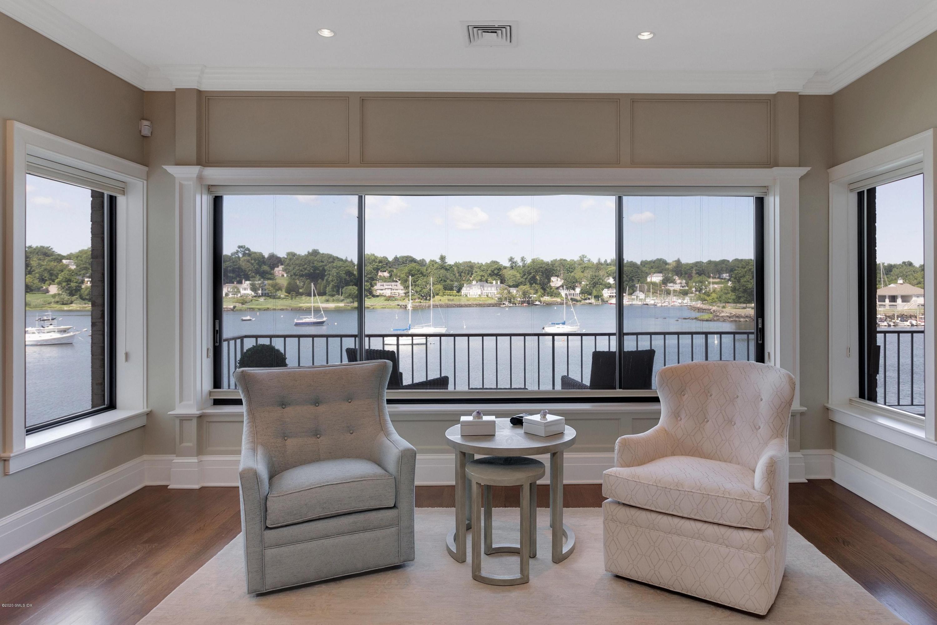 680 Steamboat Road, Unit 5 Greenwich, CT 06830 - Photo 6 of 21 a balcony with furniture and large windows