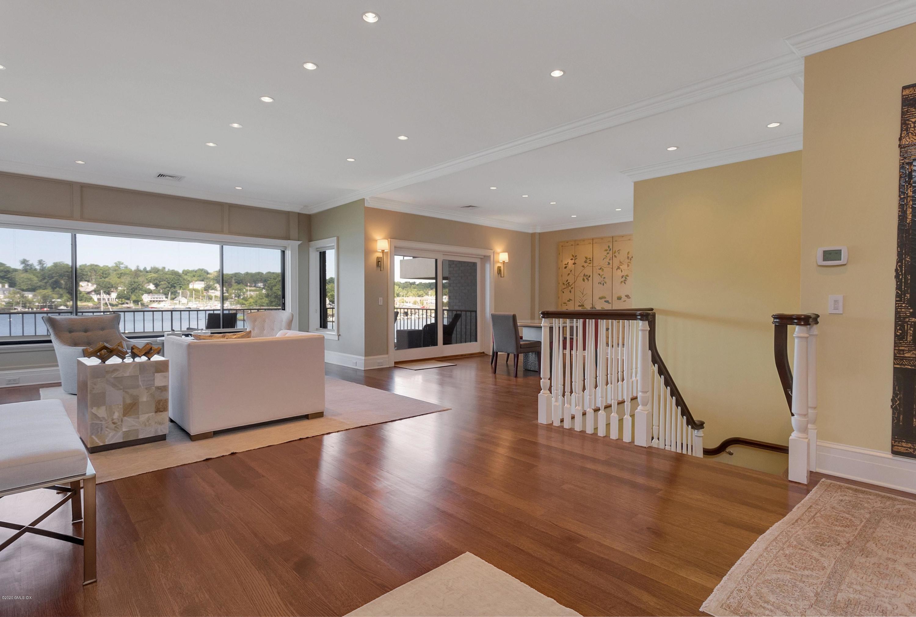 680 Steamboat Road, Unit 5 Greenwich, CT 06830 - Photo 9 of 21 a living room with furniture wooden floor and a large window