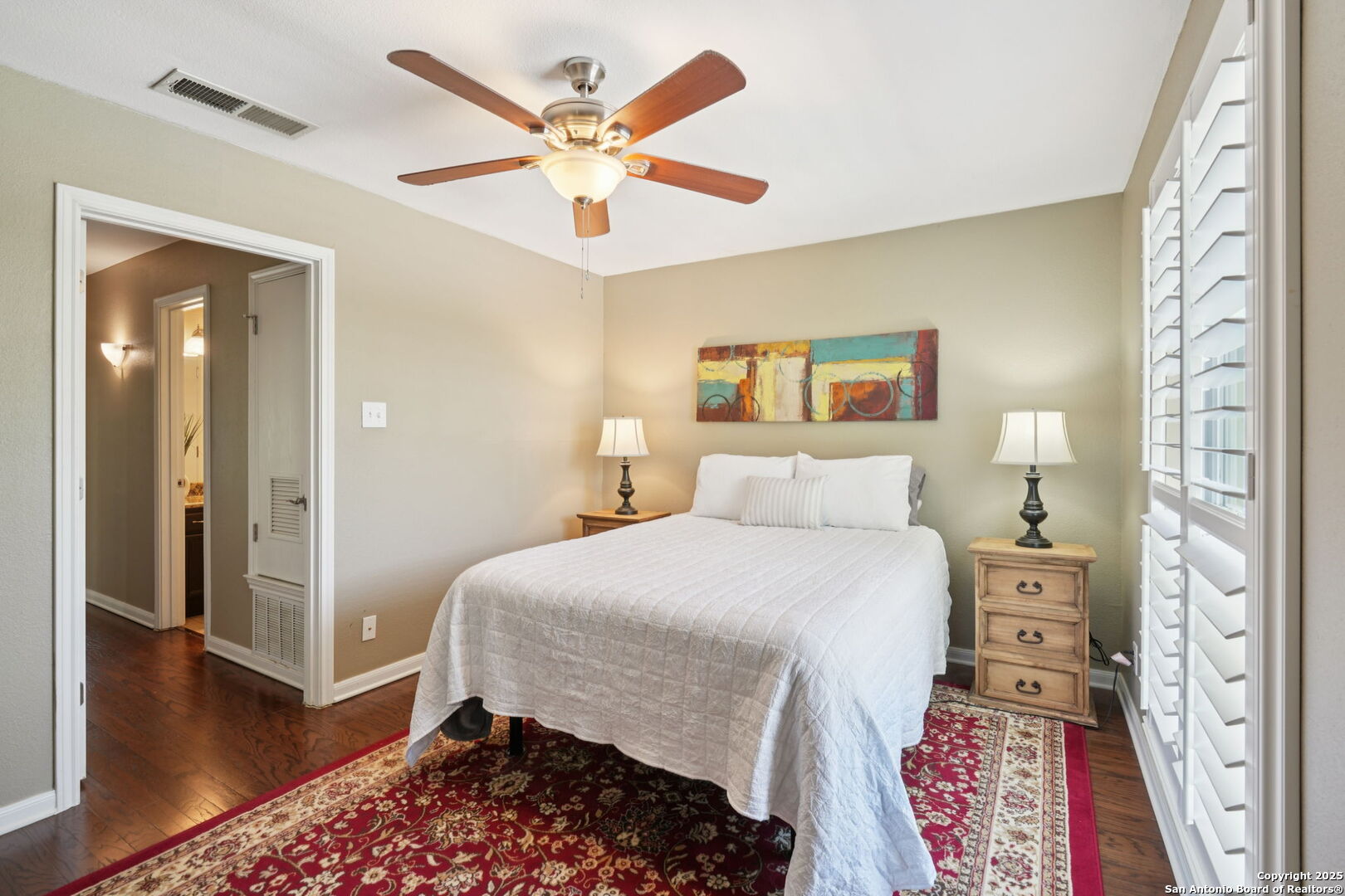 100 Lorenz Road, Unit 1204 San Antonio, TX 78209 - Photo 18 of 27 a bedroom with a bed and a chandelier