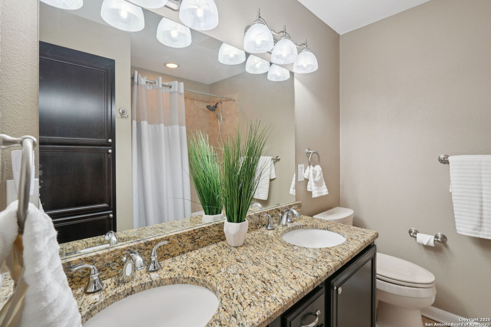 100 Lorenz Road, Unit 1204 San Antonio, TX 78209 - Photo 21 of 27 a bathroom with a granite countertop sink and a mirror