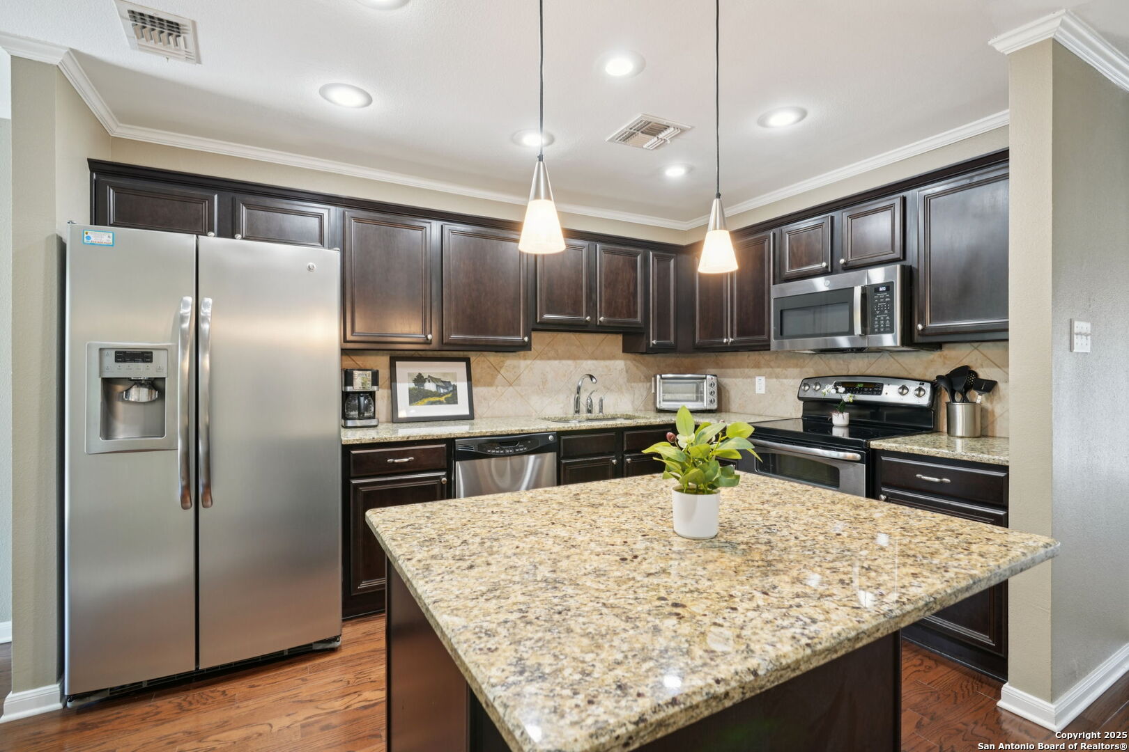 100 Lorenz Road, Unit 1204 San Antonio, TX 78209 - Photo 9 of 27 a kitchen with kitchen island a counter appliances cabinets and a sink