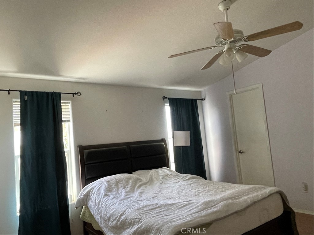 58735 Meyers Lane Anza, CA 92539 - Photo 16 of 18 a bedroom with a bed and a chandelier