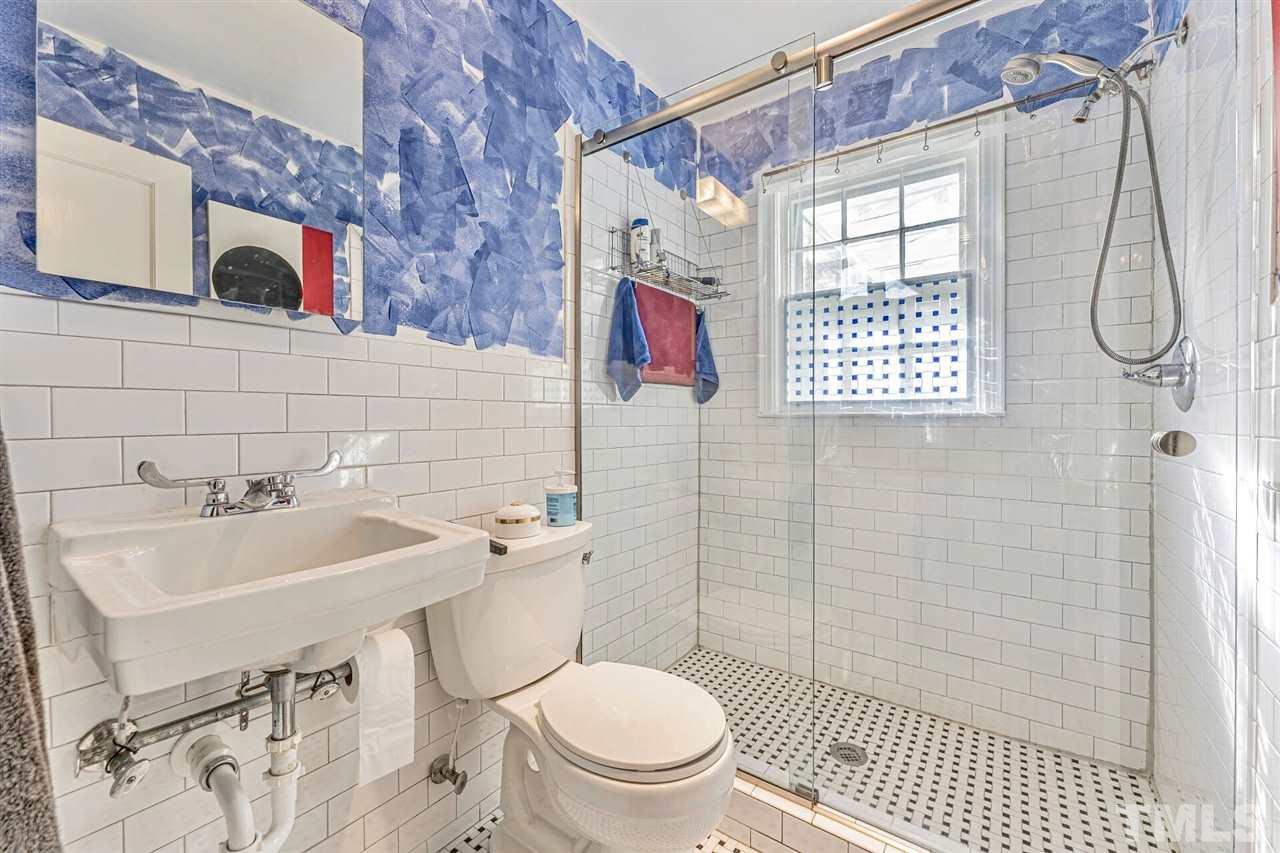 409 North King Charles Road Raleigh, NC 27610 - Photo 14 of 30 a bathroom with a sink toilet and shower